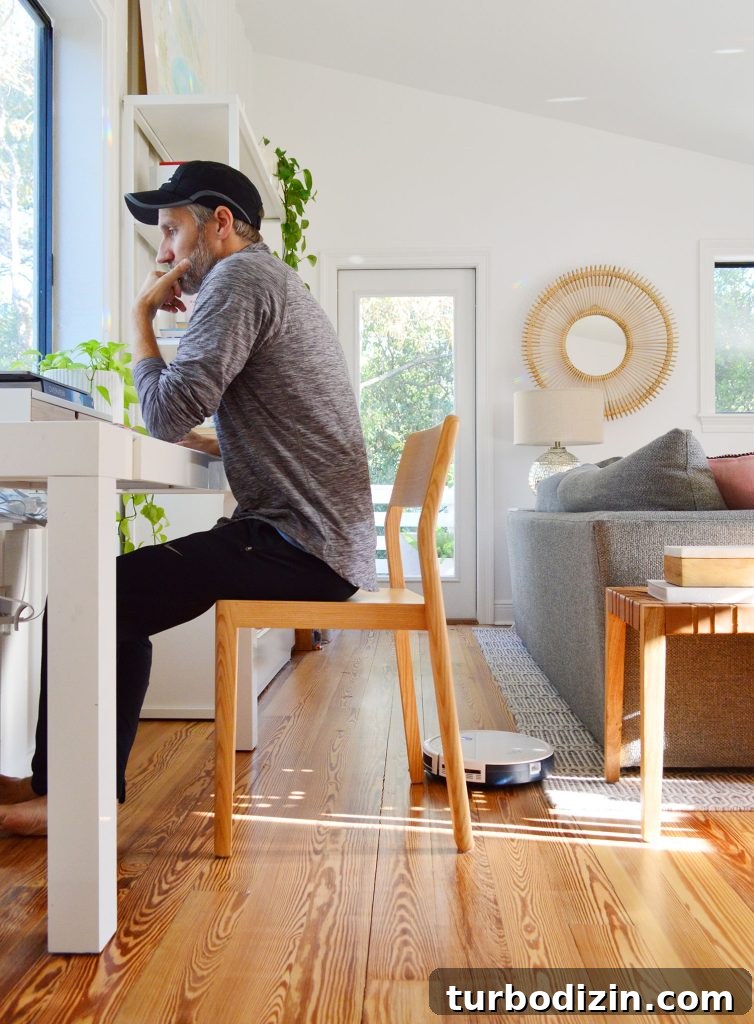 Are Robot Vacuums Worth the Investment? 6 Eufy RoboVac 11S Robot Vacuum Working Around Johns Desk Chair