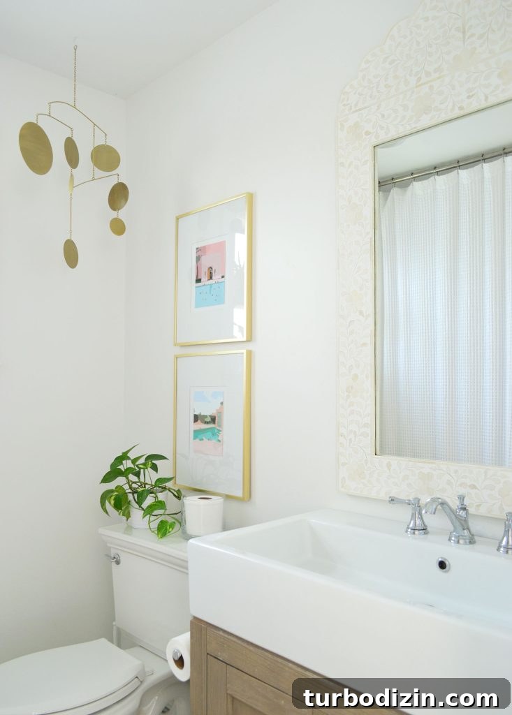 How Four People Share One Bathroom: Practical Tips That Work 10 White bathroom with inlay mirror gold picture frames and brass mobile