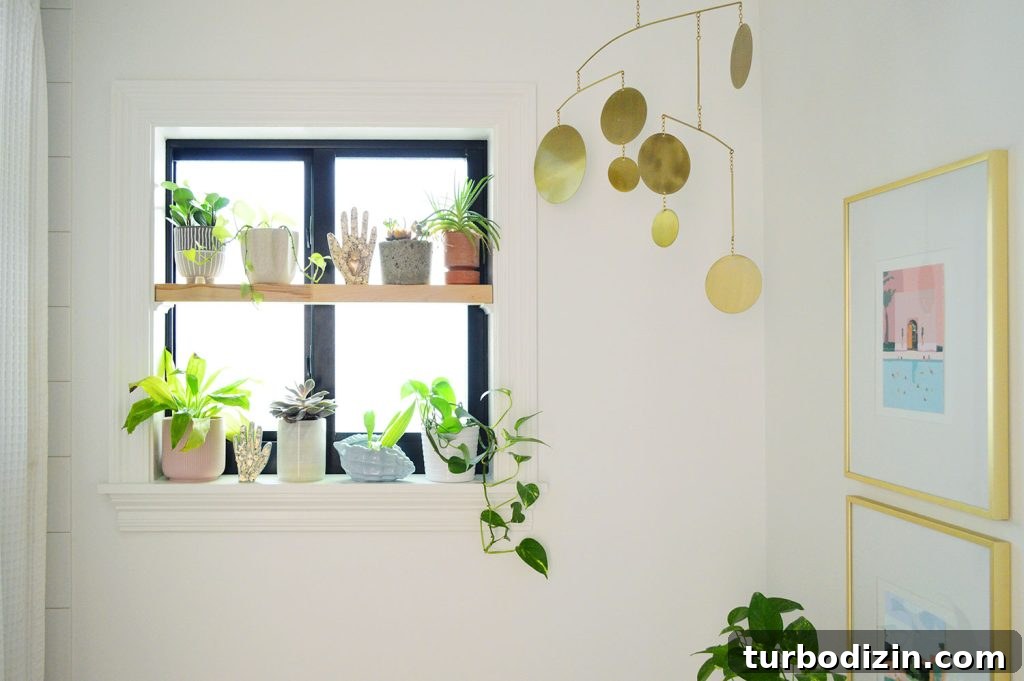 Wood window plant shelf in bathroom with gold mobile