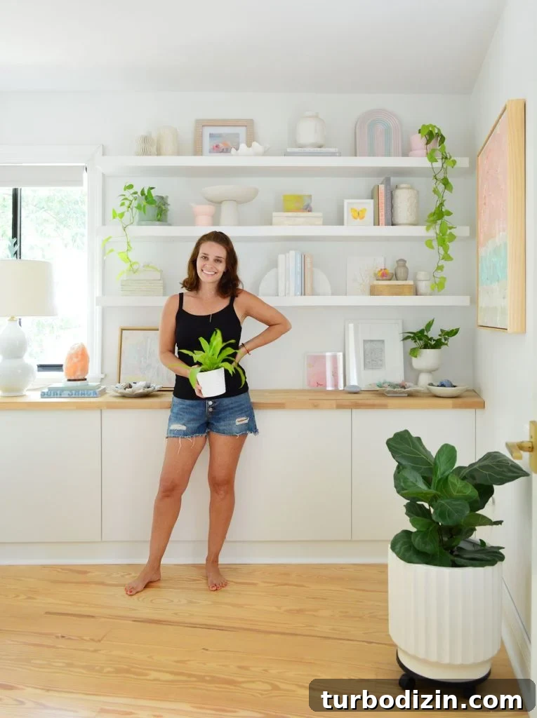 Sherry Standing With Plant In Front Of Ikea Lack Floating Shelves