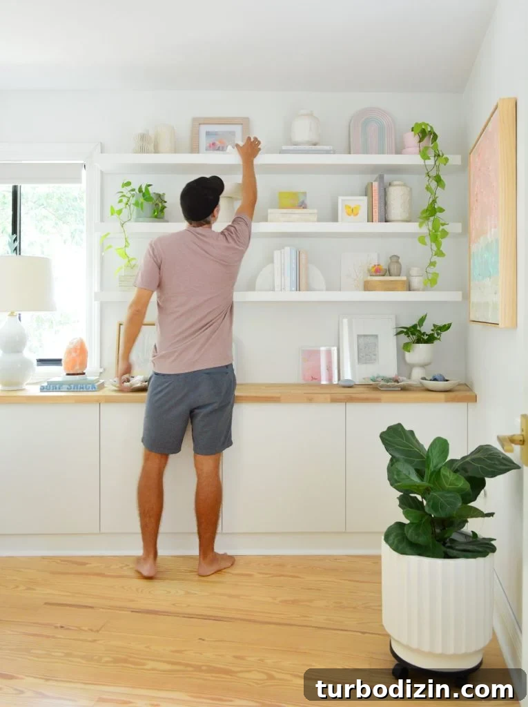 John Reaching To Top Shelf Of Three Ikea Lack Floating Shelves
