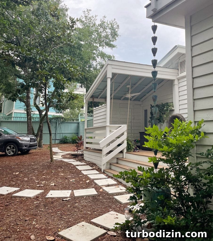 Side view of home with small stone paver walkway in front of home