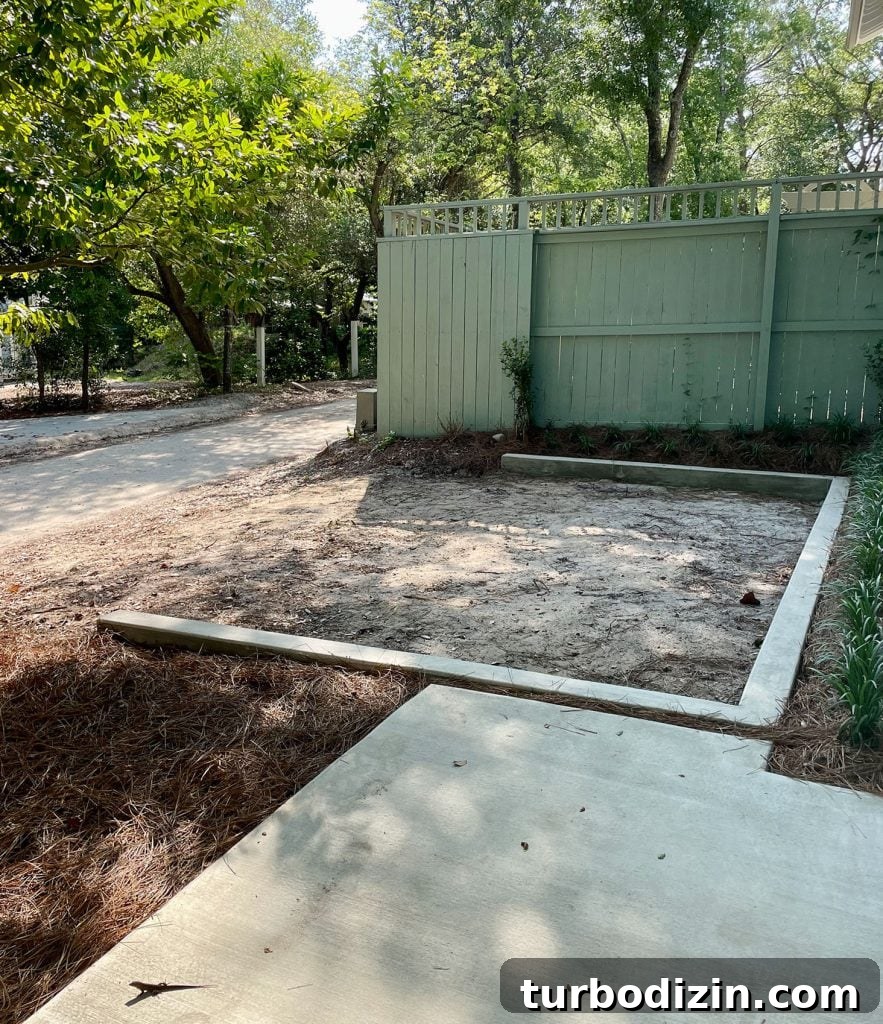 Concrete wall designating parking space by fence