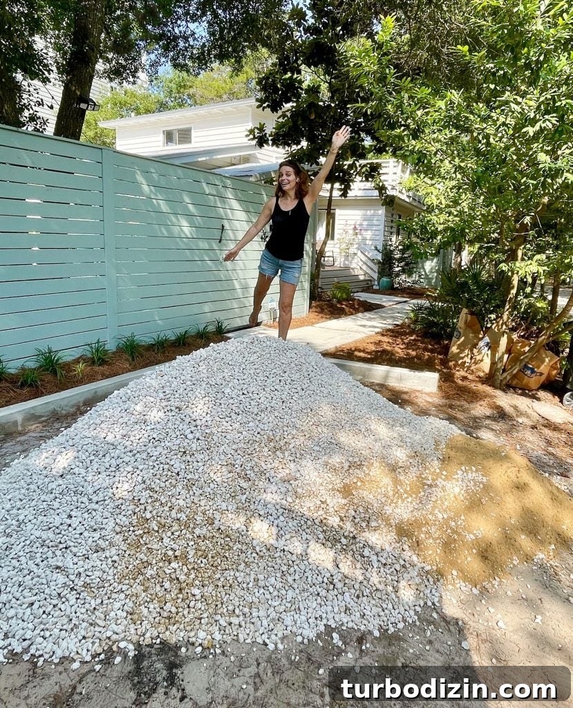 Sherry standing on top of freshly delivered pile of bahama rock gravel for driveway