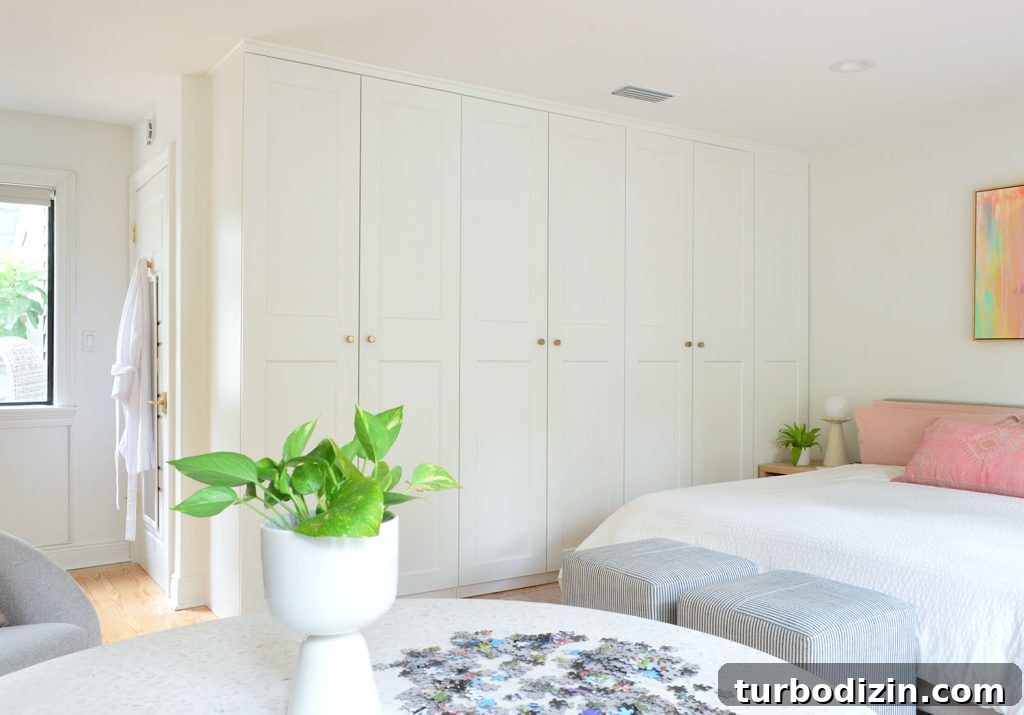 Row of Ikea Pax Wardrobes In Bedroom With Puzzle Table In Foreground