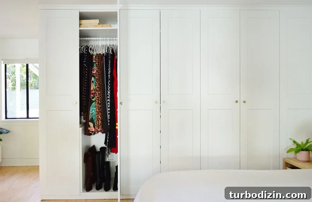How We Optimized Our IKEA PAX Closet System for Storage 3 Wall Of Ikea Pax Wardrobe Closets With One Open Door