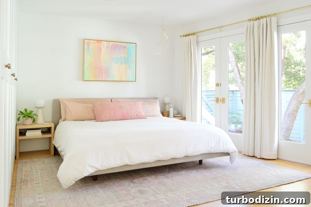 Bright Beachy Bedroom With Colorful Painting And French Door Overlooking Yard