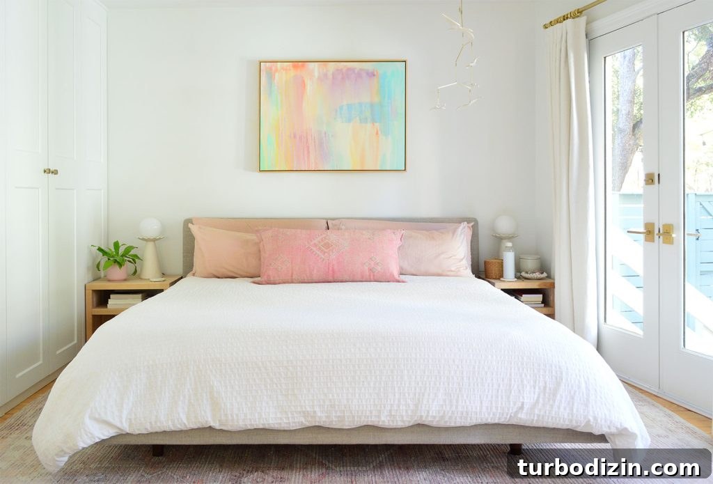 White King Bed With Pink Pillows And Bright Colorful Painting