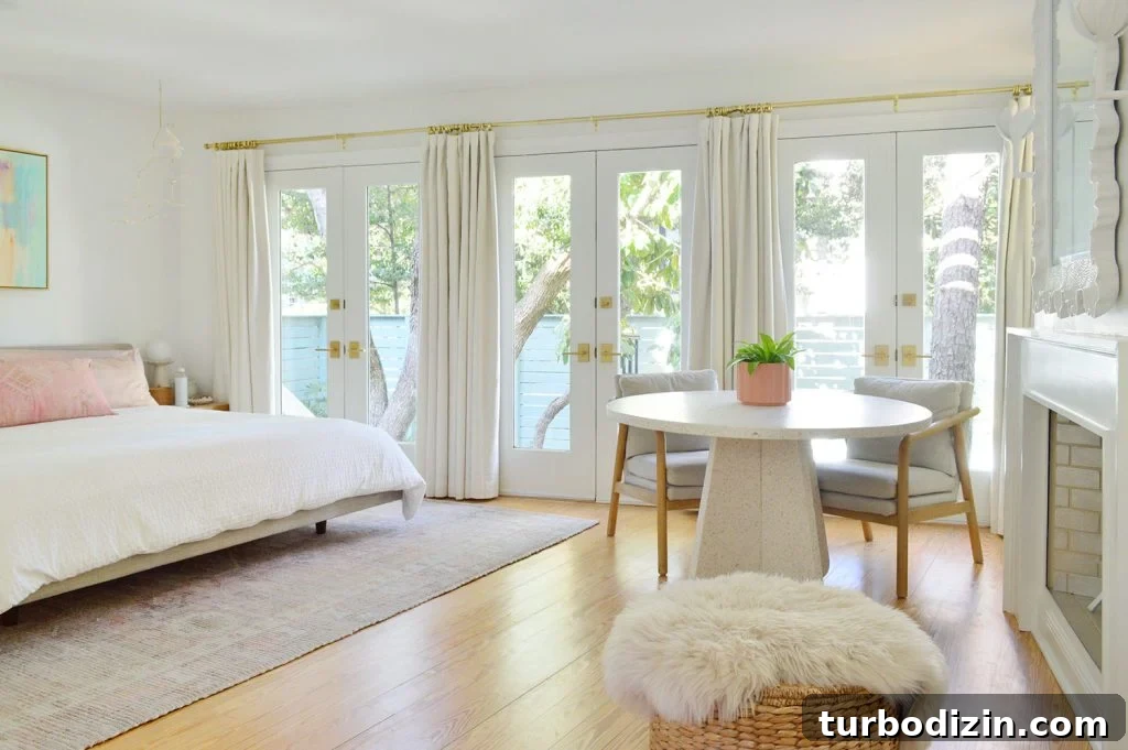 Bright Beachy Bedroom With Wall Of French Doors And Curtains