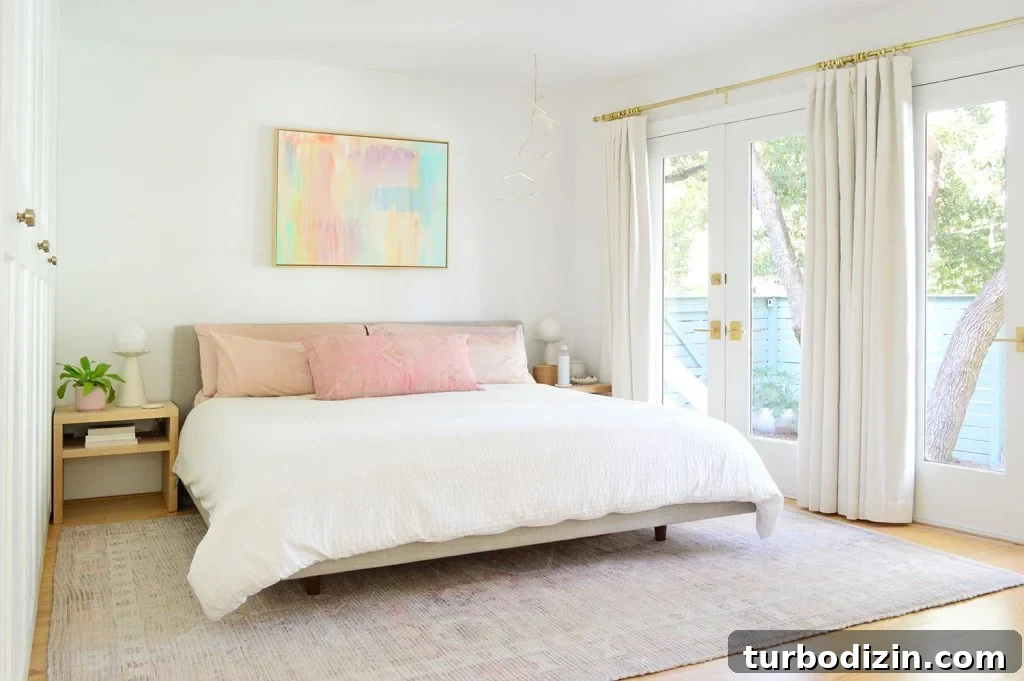 Bright Beachy Bedroom With Colorful Painting And French Door Overlooking Yard