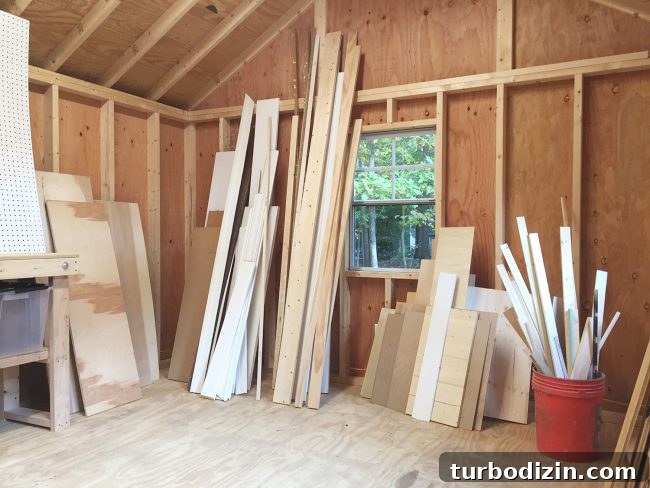 unorganized scrap wood leaned up against walls of unfinished shed