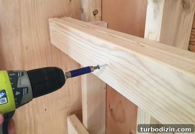 DIY Garage Shelving: Step-by-Step Guide to Build Sturdy Shelves 6 screwing in horizontal support for DIY garage shelf