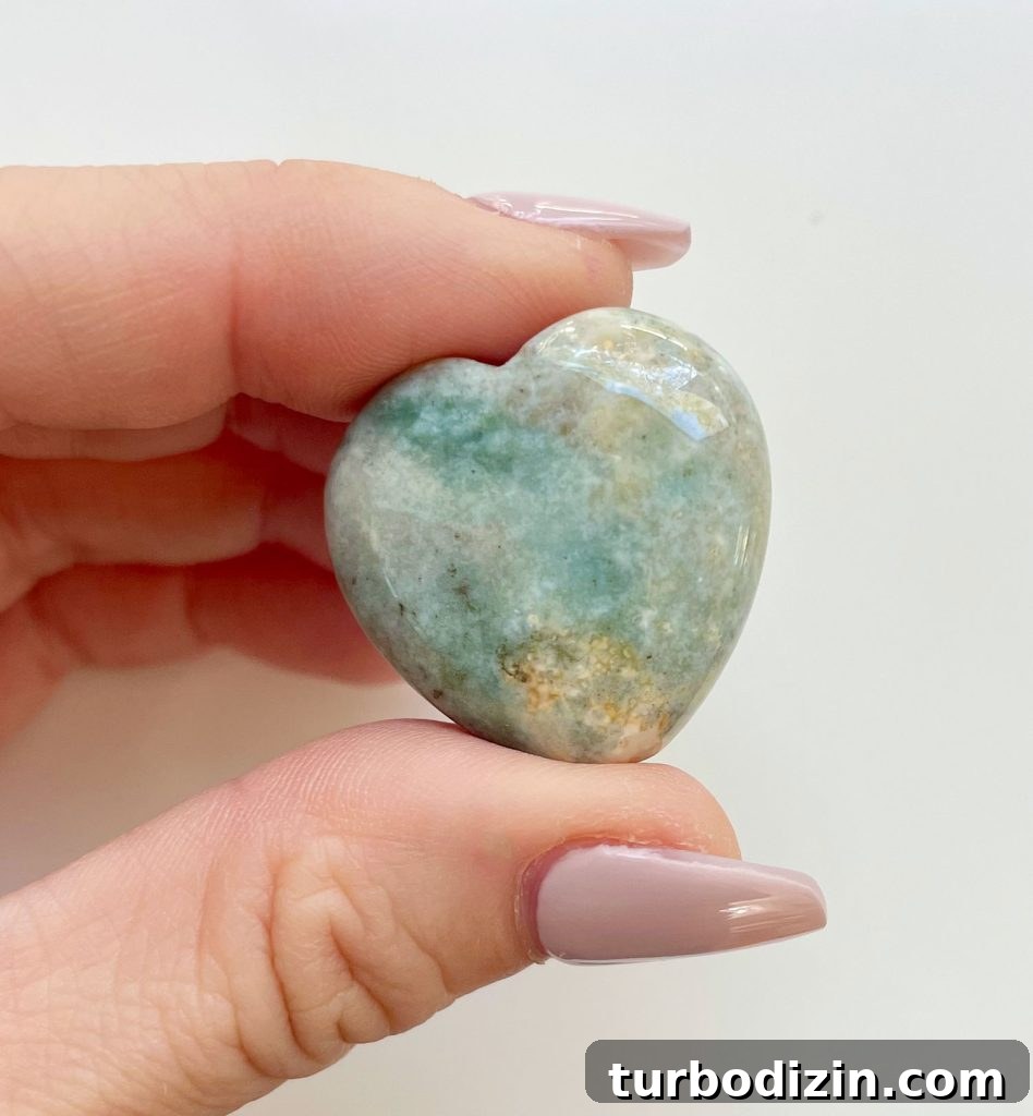 Ocean Jasper Meaning and Healing Properties: Uses & Benefits 4 Ocean Jasper Crystal Heart Between Fingertips