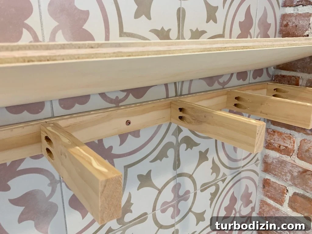 How to Install Floating Kitchen Shelves: Step-by-Step Guide 10 Plywood Top Being Lowered Onto Wooden Support Bracket For DIY Floating Shelves