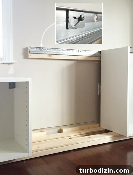 Built-In Cabinet Guide: Design, Installation, and Tips 6 detail of how Ikea Sektion cabinets attach to metal wall rail using screw and washer