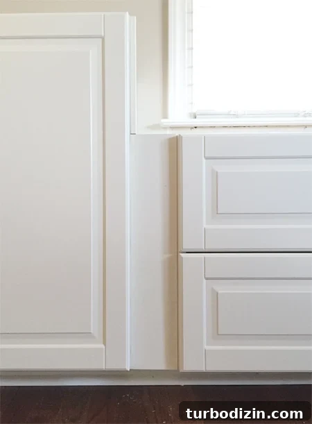 Built-In Cabinet Guide: Design, Installation, and Tips 9 filler piece between two white Ikea Sektion cabinets with Bodbyn doors creating recessed spot between doors and drawers
