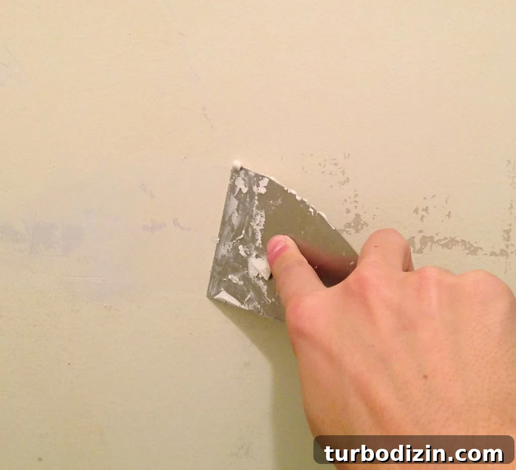 Spackling Peeled Paint Patches With A Putty Knife