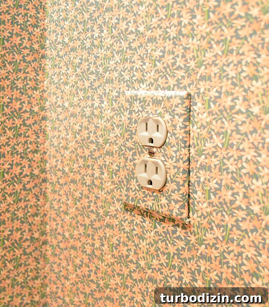 Wall outlet cover with floral wallpaper