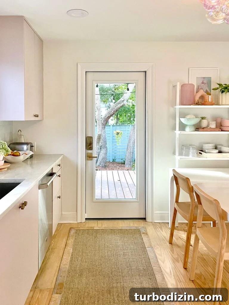 Small Kitchen With Mauve Cabinets And Doorway To Porch