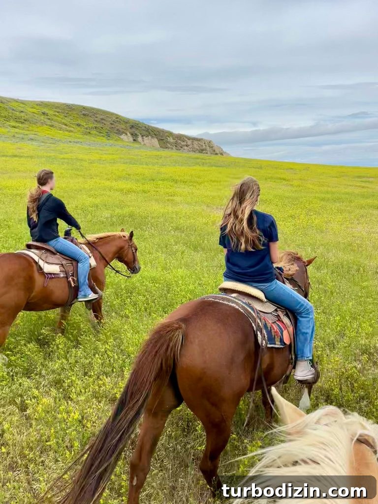 South Dakota Summer Road Trip: Top Sights & Itinerary Ideas 11 Two Girls Horseback Riding In Badlands South Dakota Among Sweet Clover