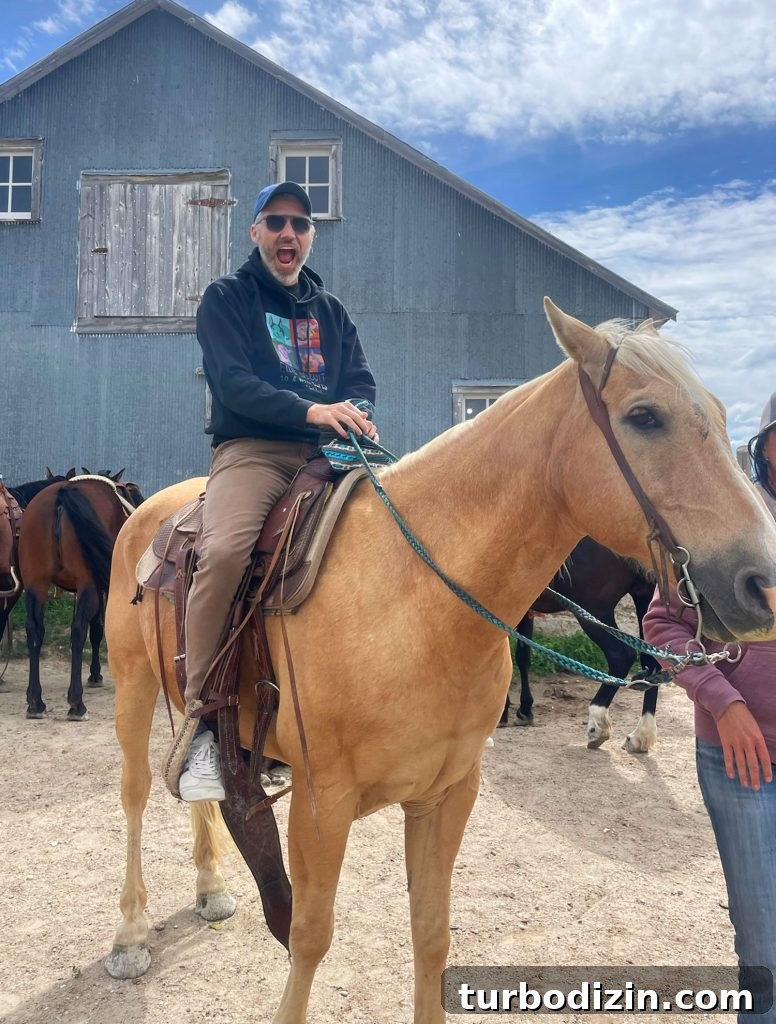 South Dakota Summer Road Trip: Top Sights & Itinerary Ideas 12 John Riding Horse In South Dakota In Front of Barn