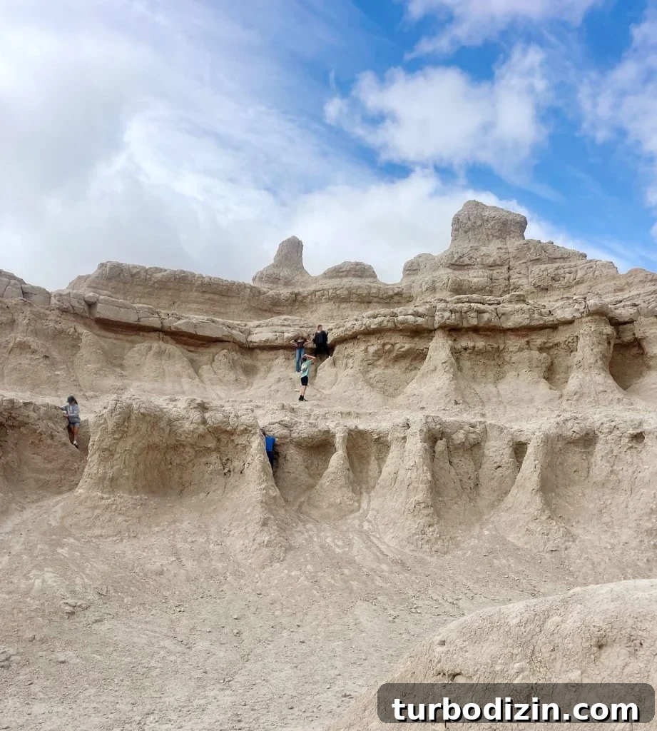 South Dakota Summer Road Trip: Top Sights & Itinerary Ideas 3 Kids Exploring Rock Formation In Badlands National Park