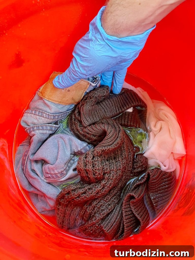 How to Dye Clothes at Home: Step-by-Step Guide for Vibrant Results 7 Pre-wetting clothes to be dyed in bucket