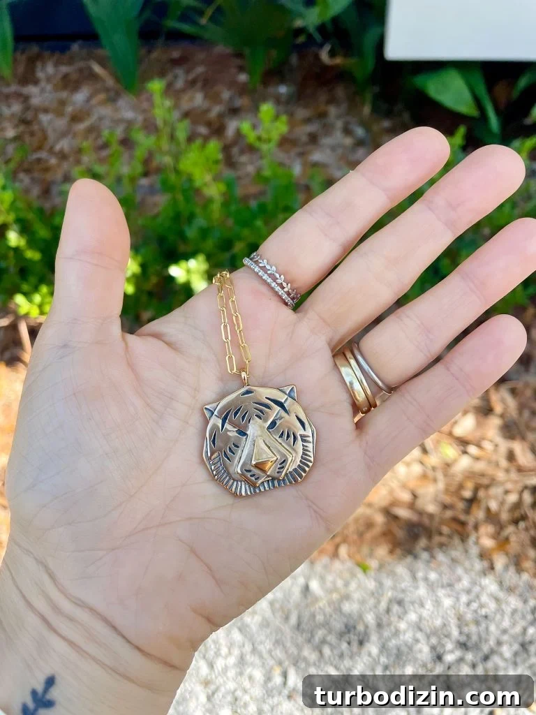 Weekend Escape to Ocean Springs: Coastal Things to Do and See 23 Sherry Hand Holding Gold Tiger Necklace Purchased at Palmette In Ocean Springs Mississippi