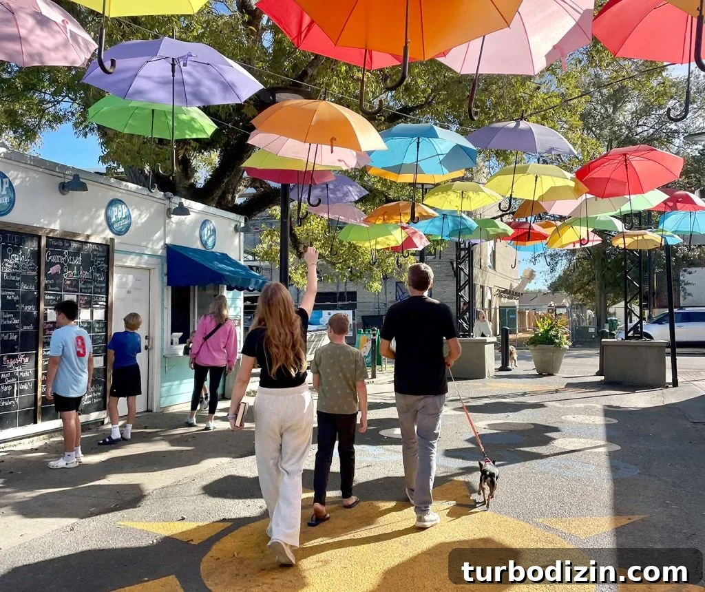 Weekend Escape to Ocean Springs: Coastal Things to Do and See 27 Kids Walking Under Bright Umbrellas In Cash Alley In Ocean Springs Mississippi
