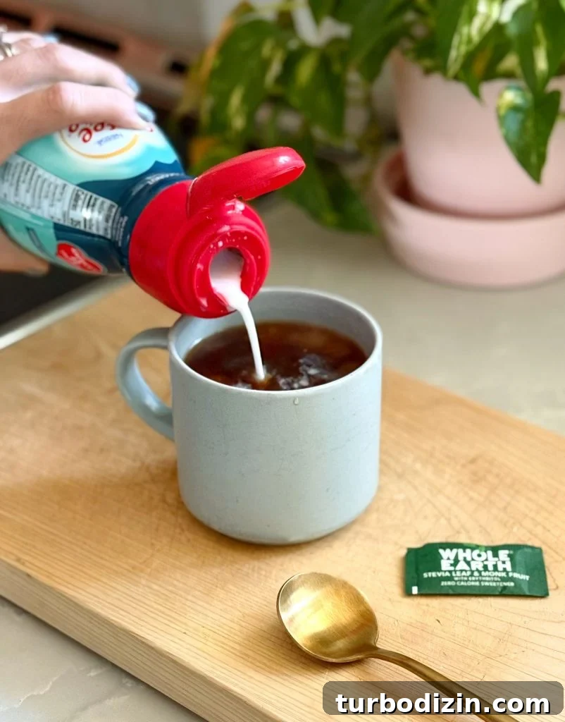 Adding Coconut Creamer To Mug of Pour Over Coffee