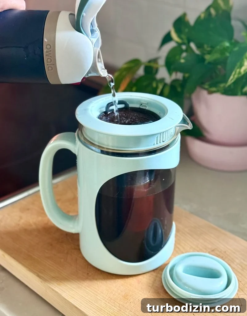 Cold Brew Coffee at Home: Step-by-Step Guide for Smooth Flavor 8 Adding Water Over Coffee Grounds In Home Cold Brew Maker