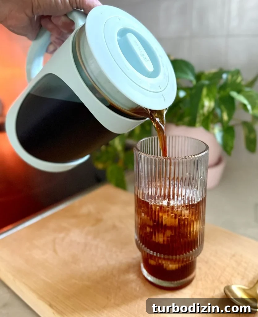 Cold Brew Coffee at Home: Step-by-Step Guide for Smooth Flavor 10 Pouring Homemade Cold Brew Into Glass With Ice