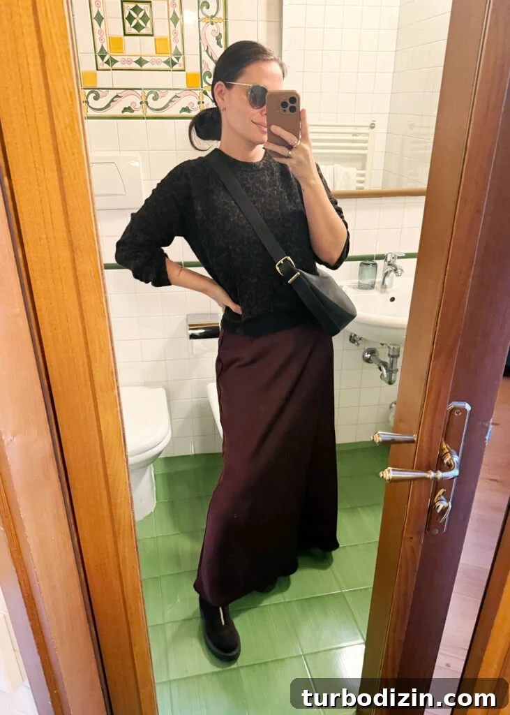 Packing Light for Italy: My Proven Minimalist Travel Wardrobe 11 Sherry Selfie In Hotel Mirror In Florence Italy With Wine Skirt And Leopard Sweater