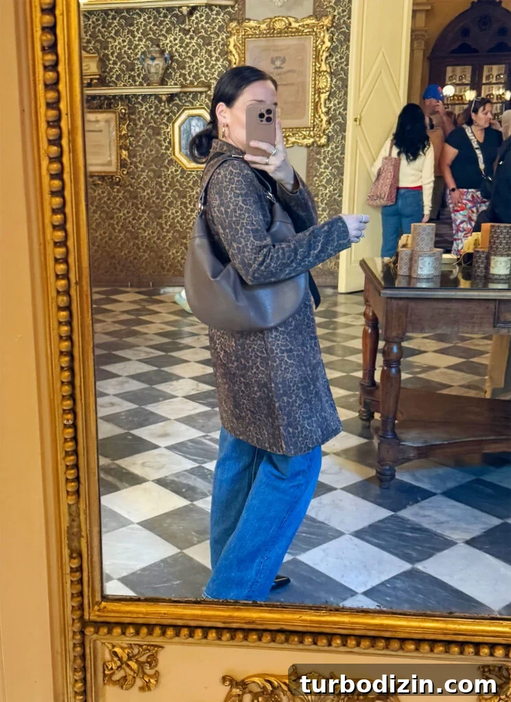 Packing Light for Italy: My Proven Minimalist Travel Wardrobe 15 Sherry Selfie In Mirror With Leopard Coat And Jeans In Florence Italty