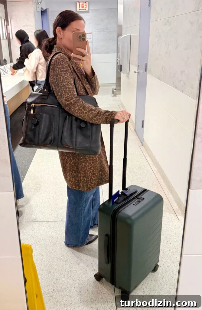 Packing Light for Italy: My Proven Minimalist Travel Wardrobe 3 Sherry Selfie In Airport Mirror With Suitcase On Trip To Italy