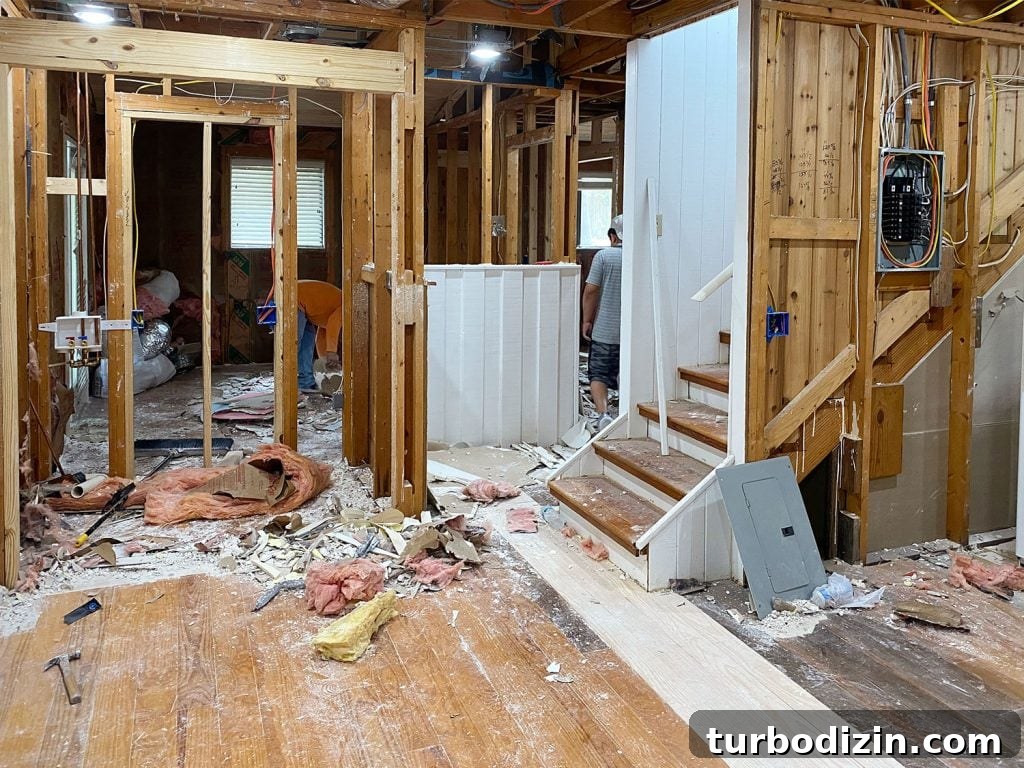 Renovating Our Home After Five Years: Before, Plans & Reveal 2 Renovation Photo With House That Has Exposed Beams And No Drywall And Dusty Floors