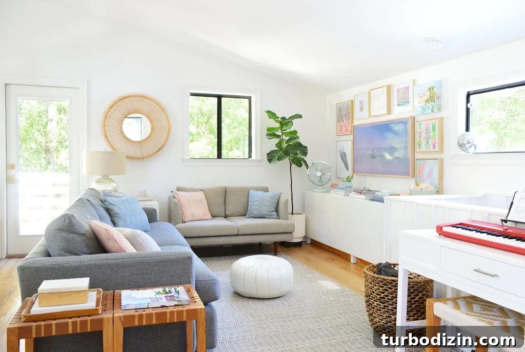 Mid-Renovation Update and Video Tour of Our Home 13 Bright Family Room With Frame TV Collage Hung On Wall
