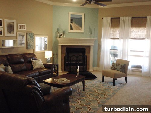18 Expert Tips for Properly Hanging Curtains and Blinds 3 living room with corner fireplace and accent blue wall and white sheer curtains on dark rod