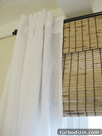 18 Expert Tips for Properly Hanging Curtains and Blinds 10 curtain-and-bamboo-roman-shade-detail-photo