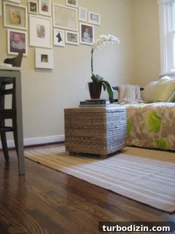 img_2131 clean hardwood floor with dash & albert striped rug and woven wicker ottoman with orchid