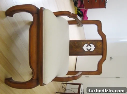 Antique chair with stained white fabric
