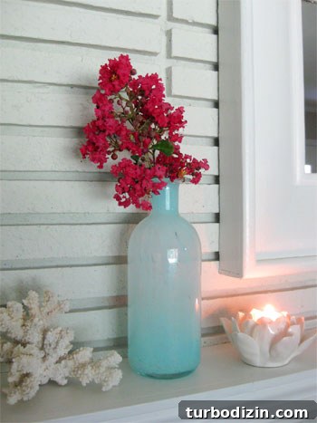 Affordable Myrtle Gardening: Grow Stunning Blooms on a Budget 2 Hot pink crape myrtle branch in blue vase on mantel