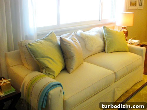 Green silk pillows on sofa