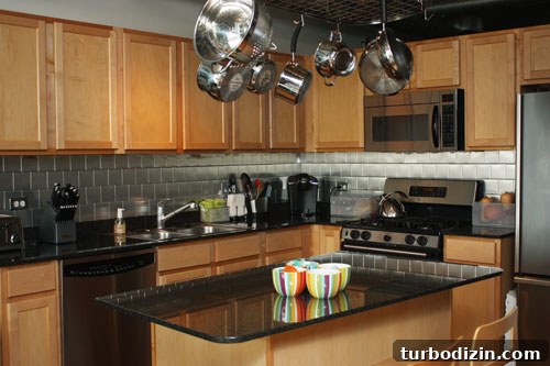 DIY Stainless Steel Stick-On Backsplash for $100 or Less 3 Backsplash after 1
