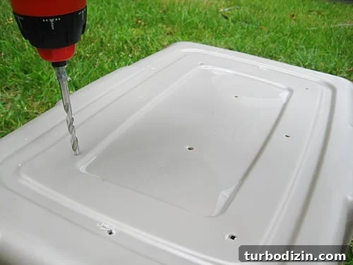 compoststep2 drilling holes in bottom of diy compost bin