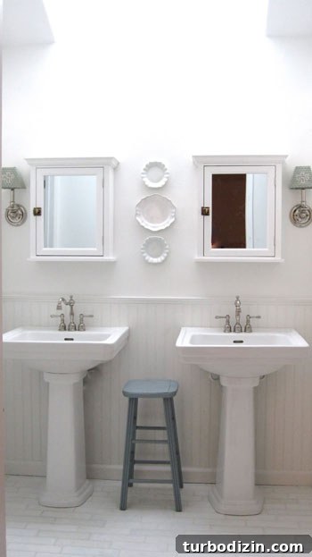 Luxe All-White Bathroom with Stylish Pedestal Sinks 3 Bathroom after renovation 1