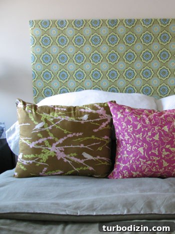 Close-up of headboard and small dog on bed