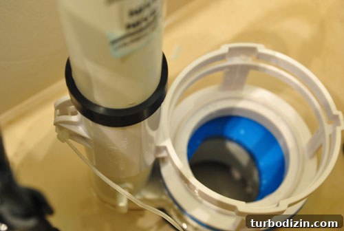 Placing dual flush converter into toilet tank