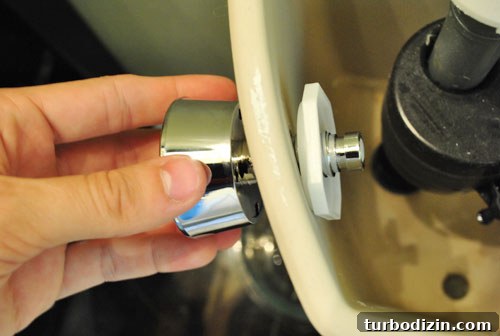 Attaching dual flush button to toilet tank