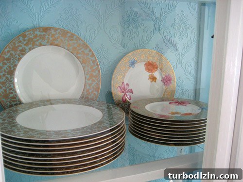 Styled china cabinet with blue wallpaper
